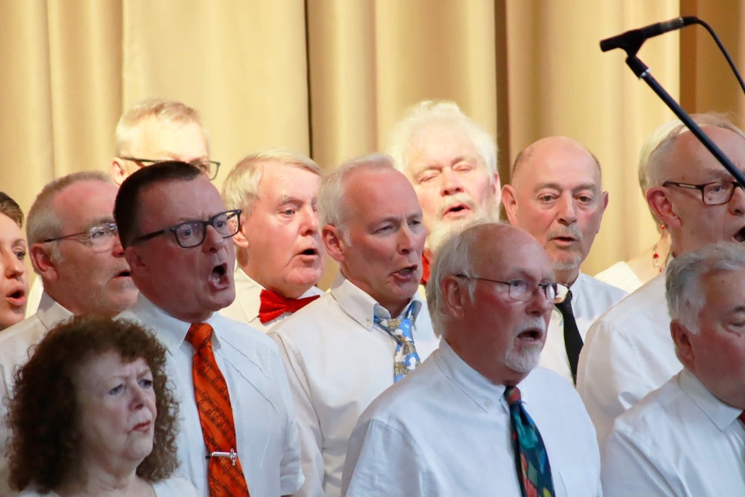 Choir members singing with passion